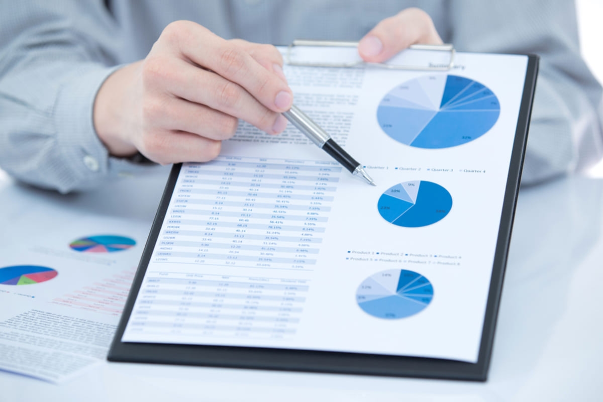 Charts and graphs on a clipboard, conducting research on the Indianapolis property management rental market concept