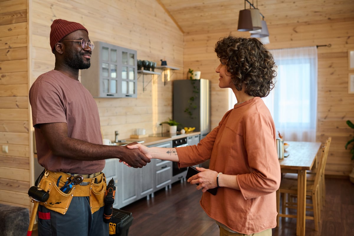 Repairman shaking hands with a woman