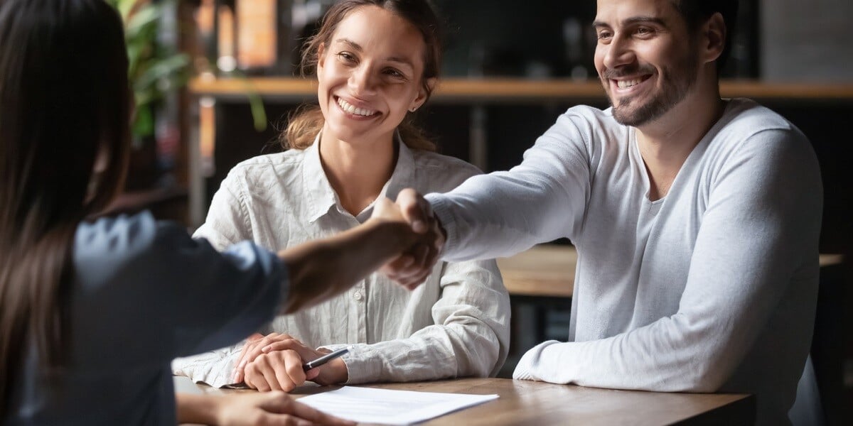 Professional shaking hands with man and woman